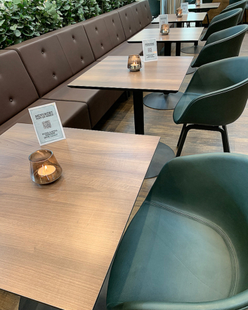 brun bænk og grønne stole i cafeområde
